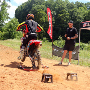 Motocross racer practicing his starts with a trainer using a Holeshot Manual Starting Gate and some Adjustable Motocross Starting Blocks