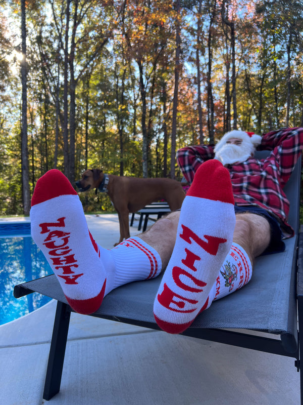 Santa wearing Riskmas socks laying poolside kicking back with his favorite moto mut Lola