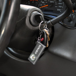 SlimJimmy Ultra-Bright Keychain Light - Grey - Lifestyle attached to a set of keys in an ignition