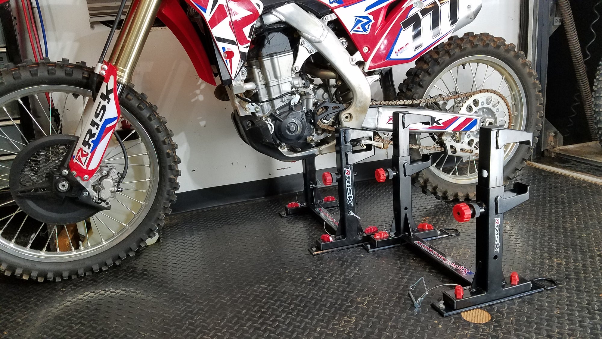 trailer with 2 lock-n-load moto transport systems. One empty and one with a dirt bike installed