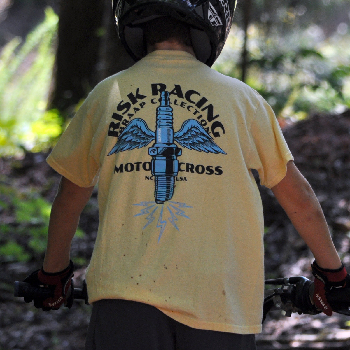 Lifestyle image of Risk Racing's Spark Wings Youth T-Shirt (Back side)
