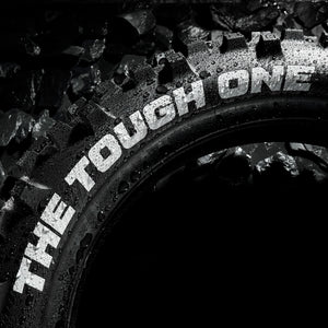 Plews Tyres - EN1 THE TOUGH ONE - Extreme Enduro Rear Tire - close up dark studio shot with water beads all over it