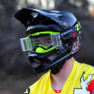 Lifestyle pic of male motocross racer wearing black helmet, Risk Racing V3 goggles, and the Ripper Auto Roll-Off system