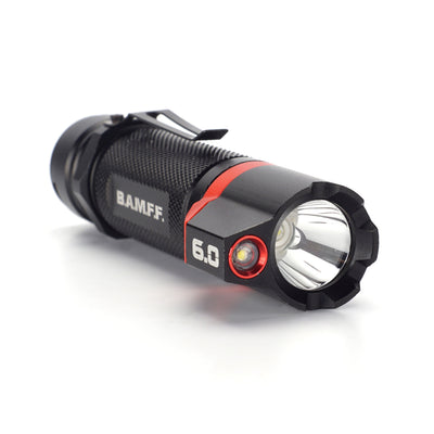 Compact black flashlight with hexagonal head and red accents, labeled 'BAMFF 6.0.'